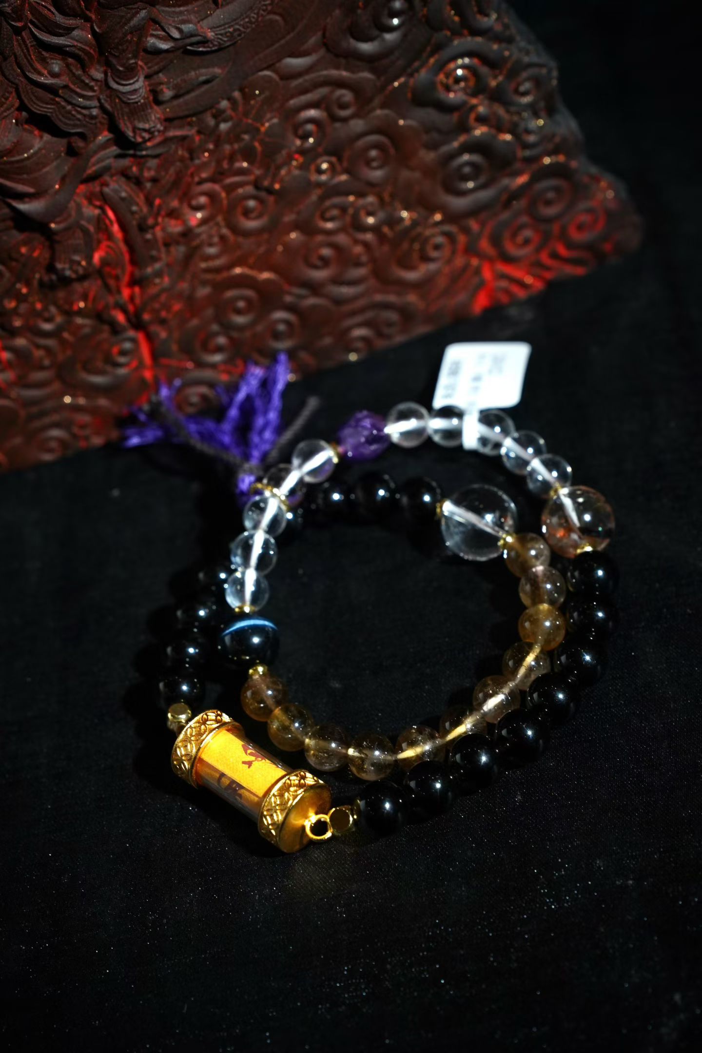Crystal and obsidian bracelet with a Taoist talisman scroll charm