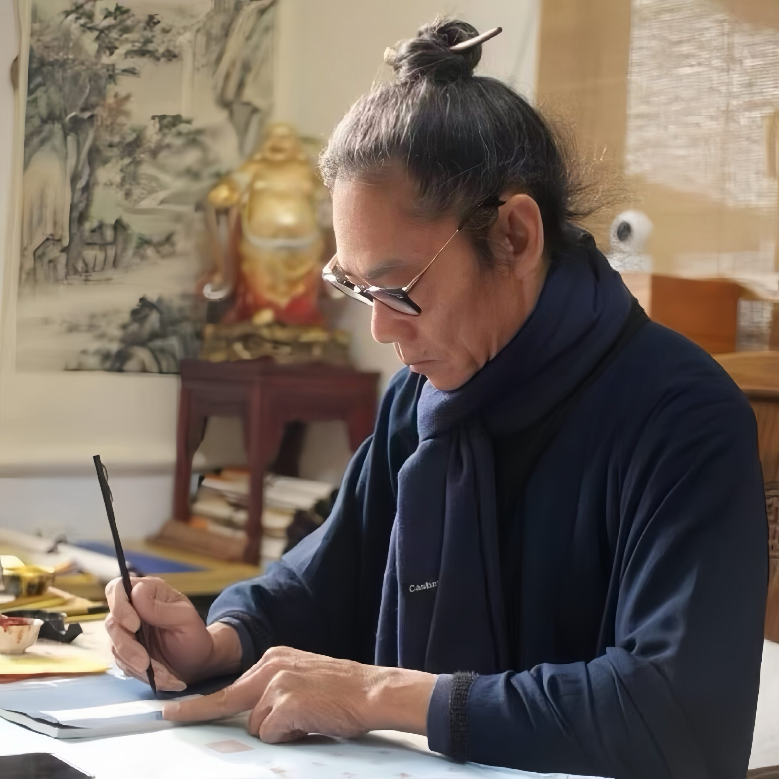 Master Mingjiu, also known as Xuanxu Daoren, hand-painting a Taoist talisman in his studio